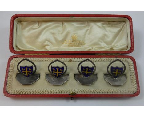 Of University College, Oxford interest; a silver and enamel set of four menu holders, of shield shape, height 3 cm, weight 2.