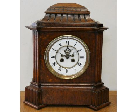 A Victorian oak mantle clock, with white enamel two part dial and visible escapement, the French movement  numbered 3406, str