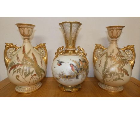 A pair of Royal Worcester blush ivory twin-handled vases of baluster form, with painted leaf decoration, the gilt handles for