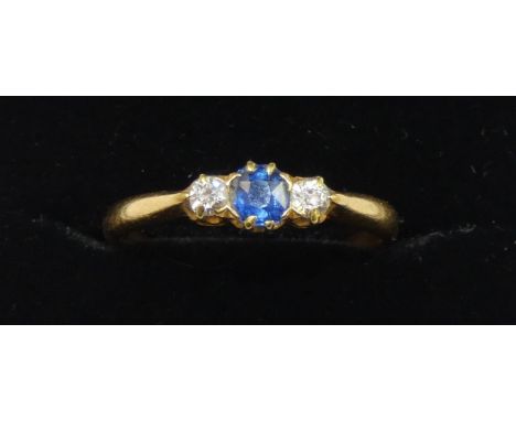 A Victorian 18ct gold sapphire and diamond three stone ring, Birmingham 1900, claw set with a mixed cut stone flanked by old 