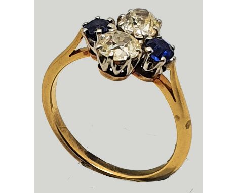 A synthetic sapphire and diamond dress ring, claw set with old cut stones, approximately 0.4 cts each, size L 1/2.