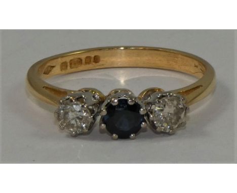 An 18ct gold sapphire and diamond three stone ring, claw set with brilliant cut stones, size O 1/2. 