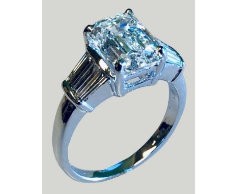 An 18ct white gold single stone certificated diamond ring, claw set with a 3.4 ct emerald cut stone, laser inscribed ACG 2004