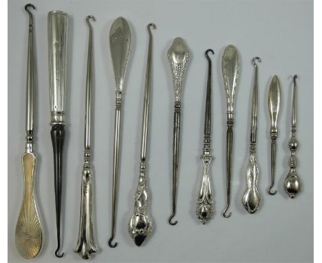 A silver handled button hook, London 1916, with engine turned decoration, length 26 cm, together with ten other examples (11)