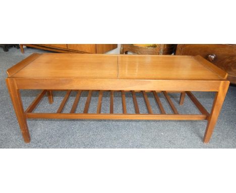 A Remploy teak extending coffee table, mid 20th century, the leaves extending, revealing a Formica centre, ladder magazine ra