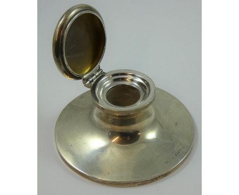 A silver capstan inkwell, Birmingham 1923, of circular form, lacking liner, diameter 13 cm, loaded. 