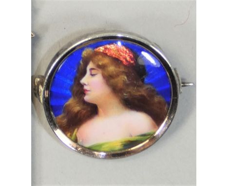 A German Art Nouveau silver and enamel brooch, by Meyle &amp; Mayer, c.1905, 900 standard, depicting a lady, diameter 25 mm.