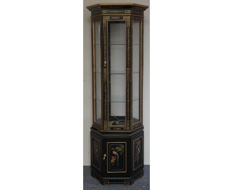 A Chinoiserie black painted octagonal display cabinet, with gilt decoration, the lower panels painted with birds and flowers,