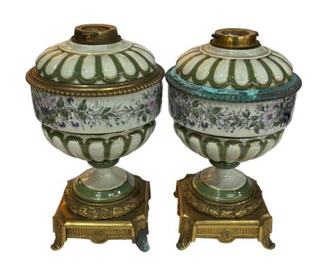 Pair of floral porcelain and gilt metal oil lamp bases, 34cm high.