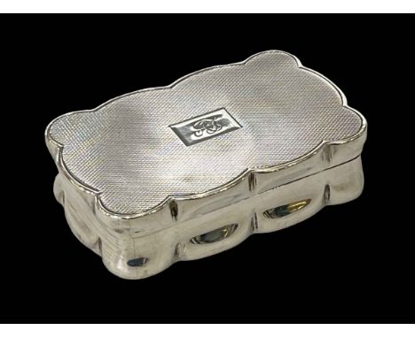 Silver engine-turned snuff box of shaped form, London 1939, 7cm across.