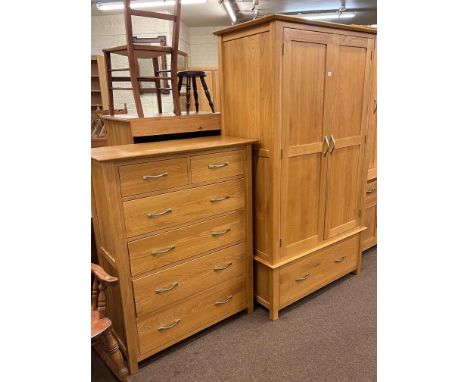 Contemporary light oak two door wardrobe with base drawer, 191cm by 110cm by 59cm and matching chest of two short above four 