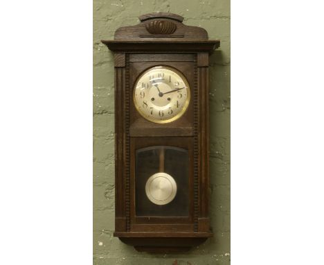 Edwardian oak cased wall clock with brass and silvered dial chiming on a coiled gong.