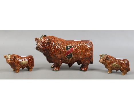A large 70cl Rutherford's Scotch Whisky Bull and two smaller 5cl examples, all full and sealed.