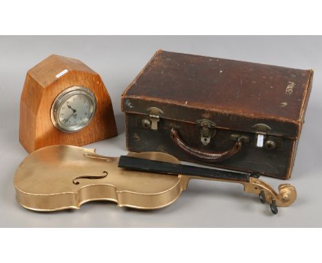 A small leather suitcase, oak cased Smith mantle clock and gold painted violin.