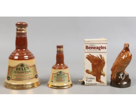 Three sealed advertising decanters to include two Wade examples for Bells Scotch Whisky and a boxed golden eagle miniature by