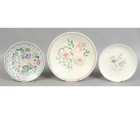 Three Poole plates one decorated with antelope and flowers. Condition Report. To be used as a guide only. No damage.