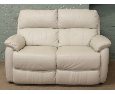 A cream leather two seat sofa.