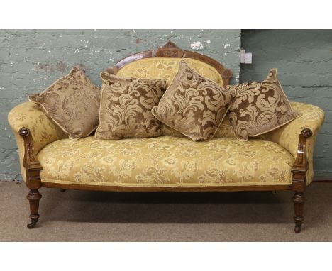 A Victorian inlaid walnut dome back parlour sofa re-upholstered in gold floral material raised on turned castered legs. Condi