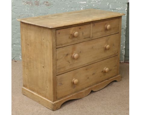 A pine two over two chest of drawers.