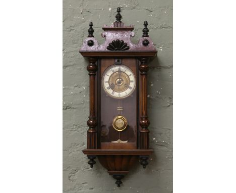 A walnut 15 day time and strike wall clock.