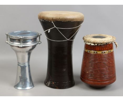 Three bongo type drums to include terracotta based example (damaged) a carved hardwood and a formed alluminium mark stagg uni