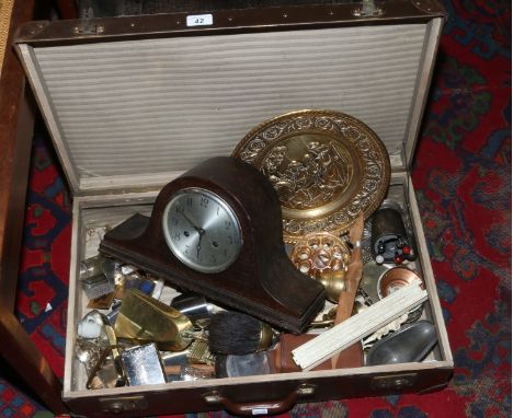 A vintage suitcase and contents to include oak mantle clock, metalwares etc.