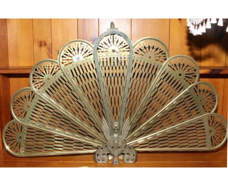 A brass peacock firescreen.