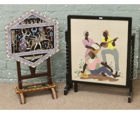 A barleytwist folding feltwork firescreen / occasional table, along with a similar inlaid with Egyptian scene.