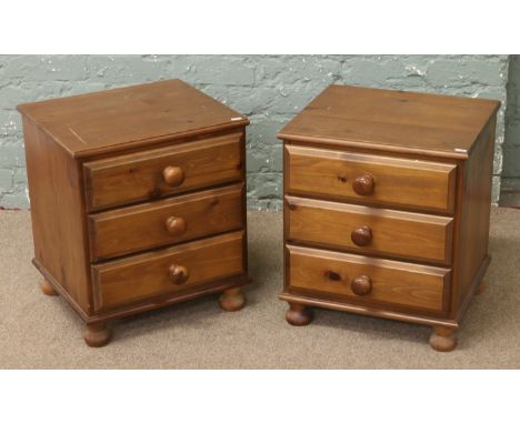 A pair of pine bedside chests of drawers.