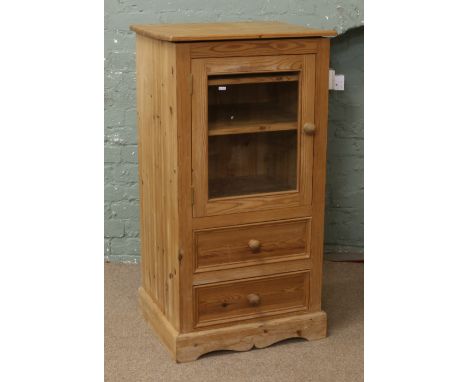 A carved pine glass front hifi cabinet over two storage drawers.