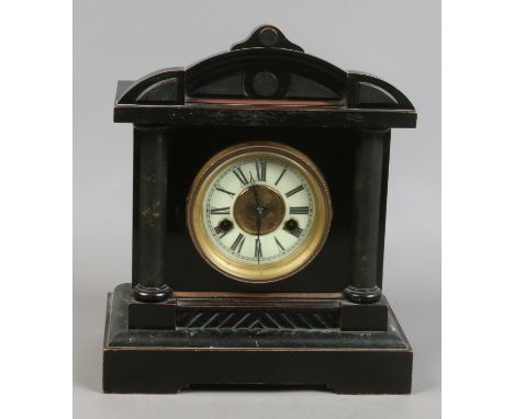 An early 20th century presentation ebonized mantle clock housing twin train movement striking on coiled gong with key and pen