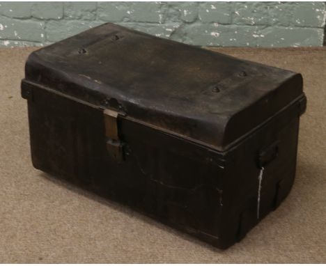 A tin trunk with twin handles.