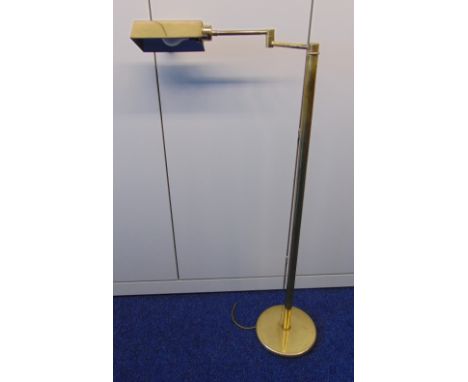 A brass free standing reading light of tubular form, rectangular shade with hinged arm all on circular base, 119cm (h)