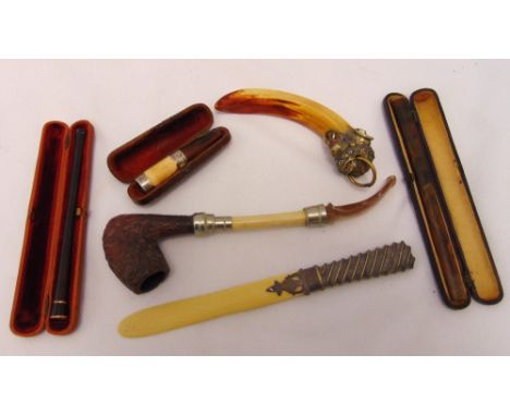 A quantity of collectables to include a paper knife, cheroot and cigarette holders in fitted cases and a pipe (6)