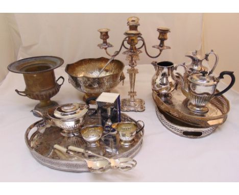 A quantity of silver plate to include trays, a punch bowl and ladle, a teaset, a candelabrum, a coffee pot and a water jug