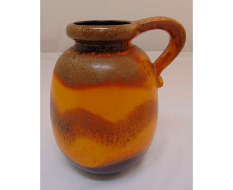 A mid 20th century continental polychromatic ceramic jug  with scroll handle, 30cm (h)