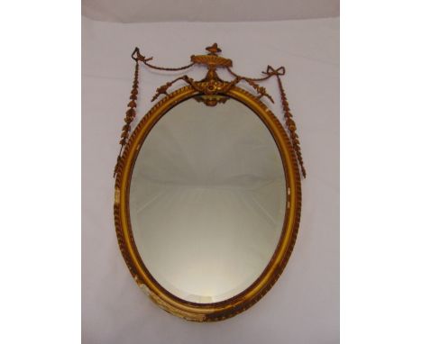A Regency style oval wall mirror with rope twist borders and husk swags, A/F, 90 x 52cm