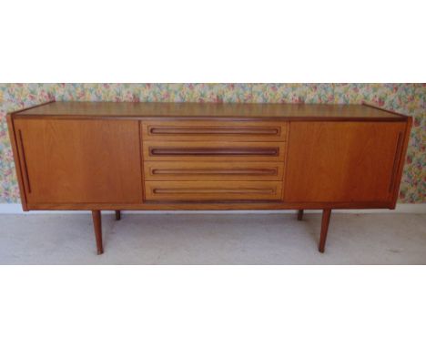 A teak rectangular mid 20th century sideboard with four drawers and two cupboards on four tapering supportS, 80 x 200 x 50cm
