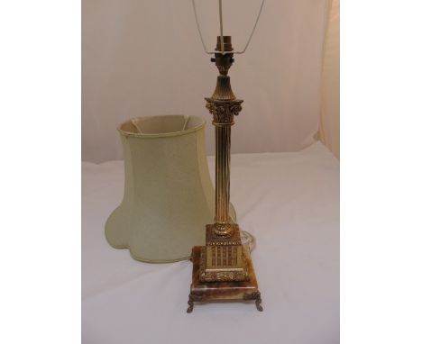 A gilt metal table lamp of Corinthian column form on raised square base with scroll supports to include silk shade, 55cm (h)