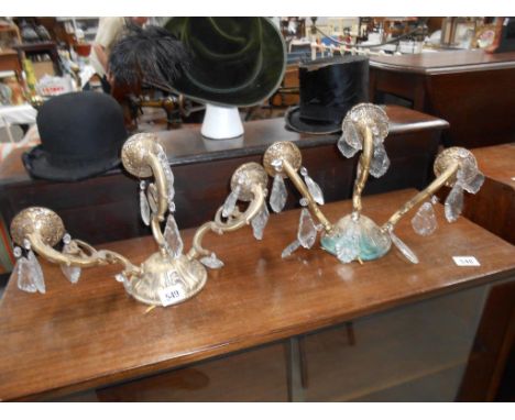 A pair of triple lamp wall lamps