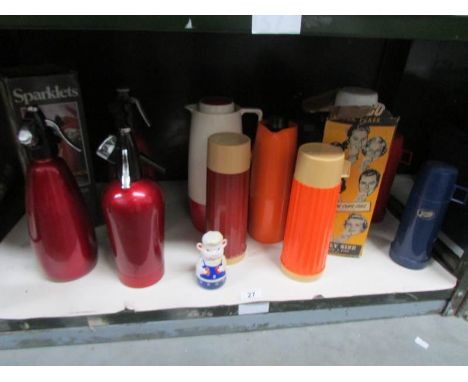 A shelf of soda syphons and vacuum flasks