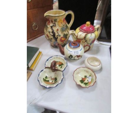 A teapot, a jug and a quantity of motto ware