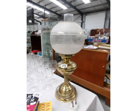 A brass table lamp in the form of an oil lamp