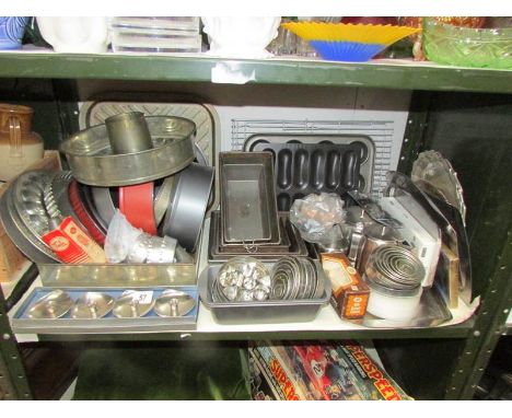 A shelf of assorted baking tins etc