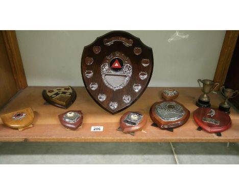 A shelf of trophies including golf