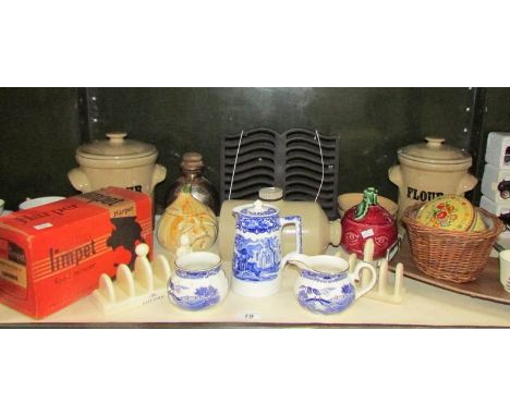 A shelf of miscellaneous items including storage jars, blue and white china etc