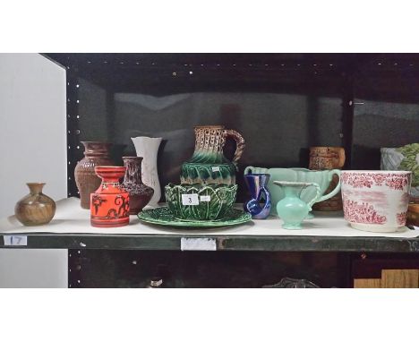 A shelf of miscellaneous pottery etc