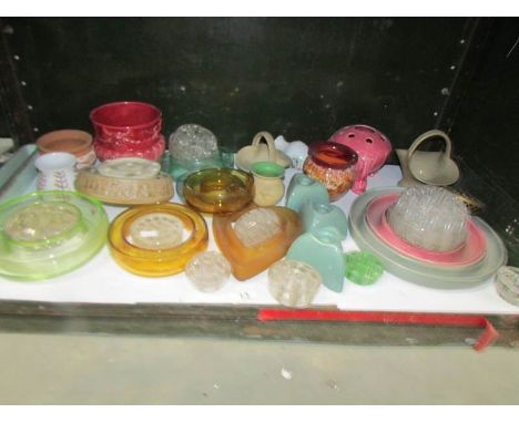 A shelf of glass flower holders etc