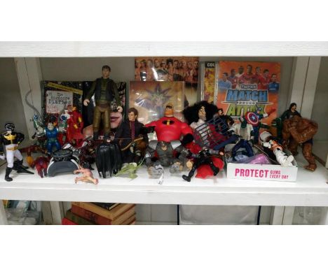 A collection of action figures, toys and cards, wrestling books, Yu gi Oh cards, magic etc