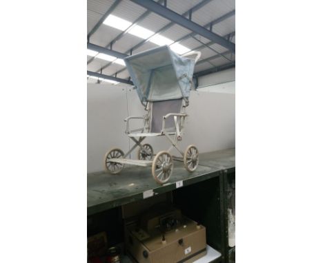 A vintage folding dolls pushchair